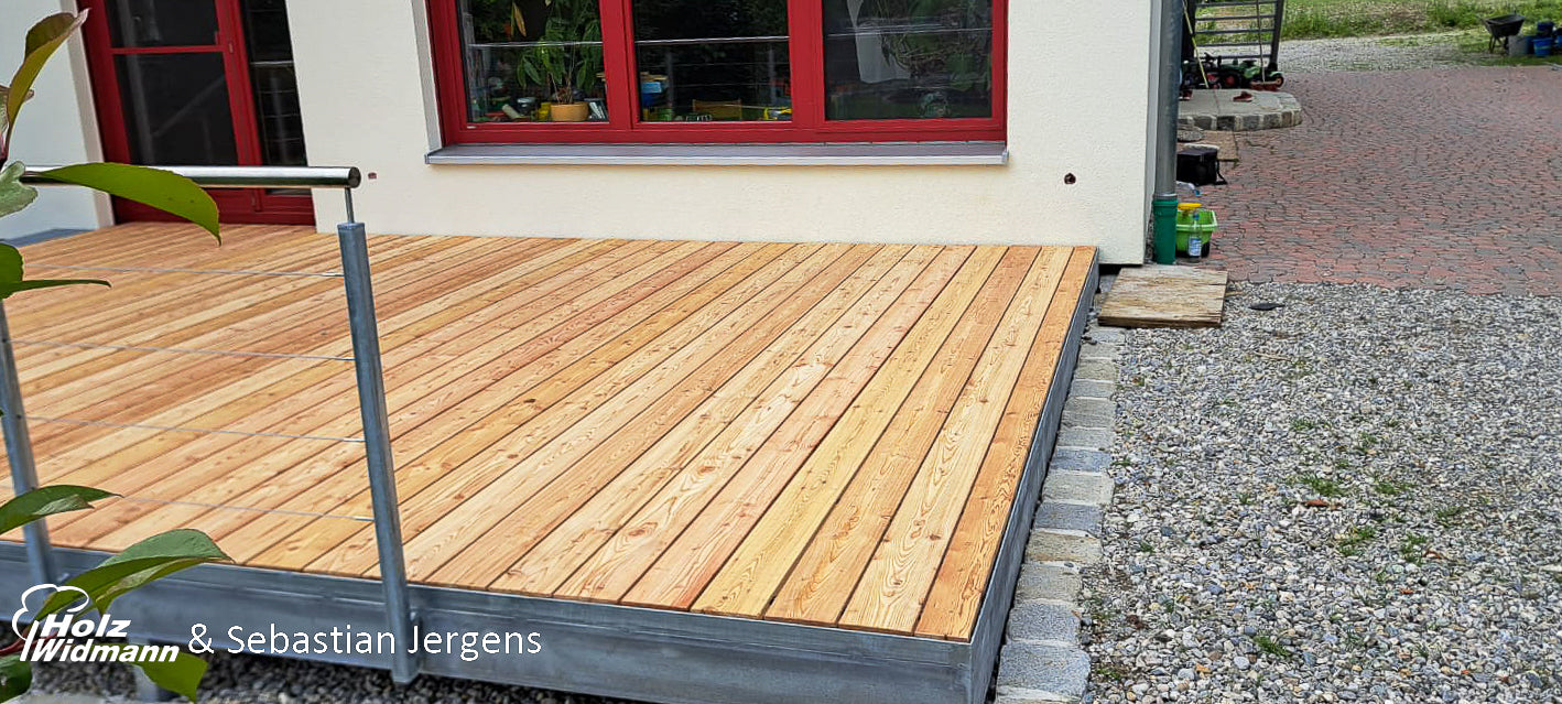 a wooden deck in front of a house